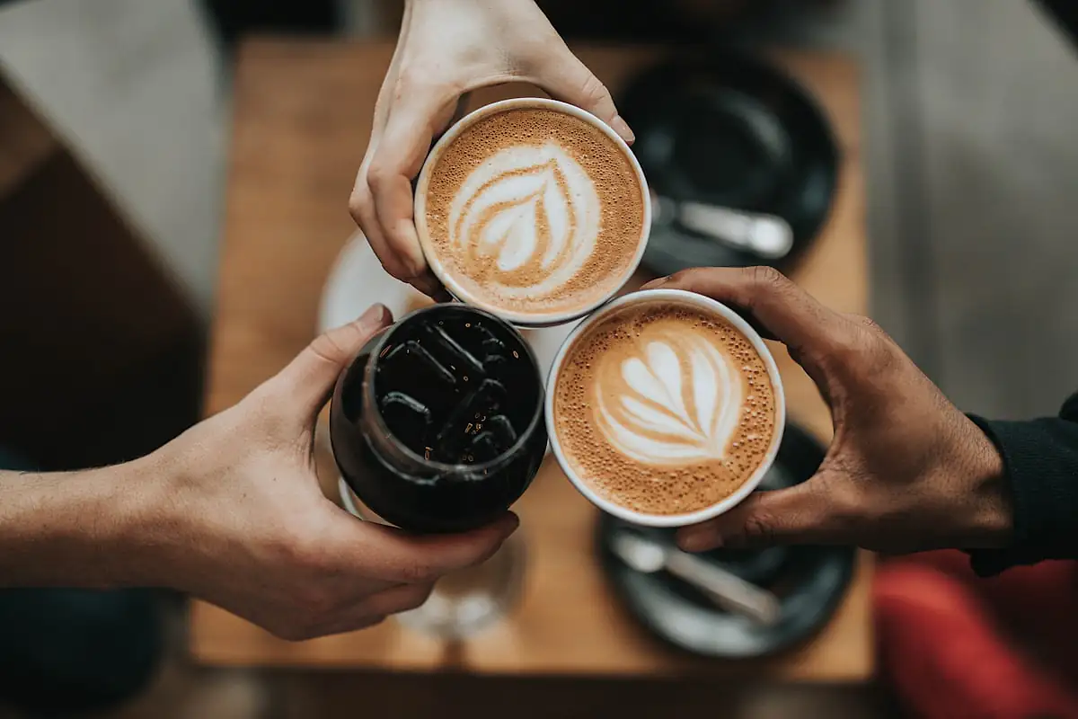 Warm latte art on a wooden cafe table